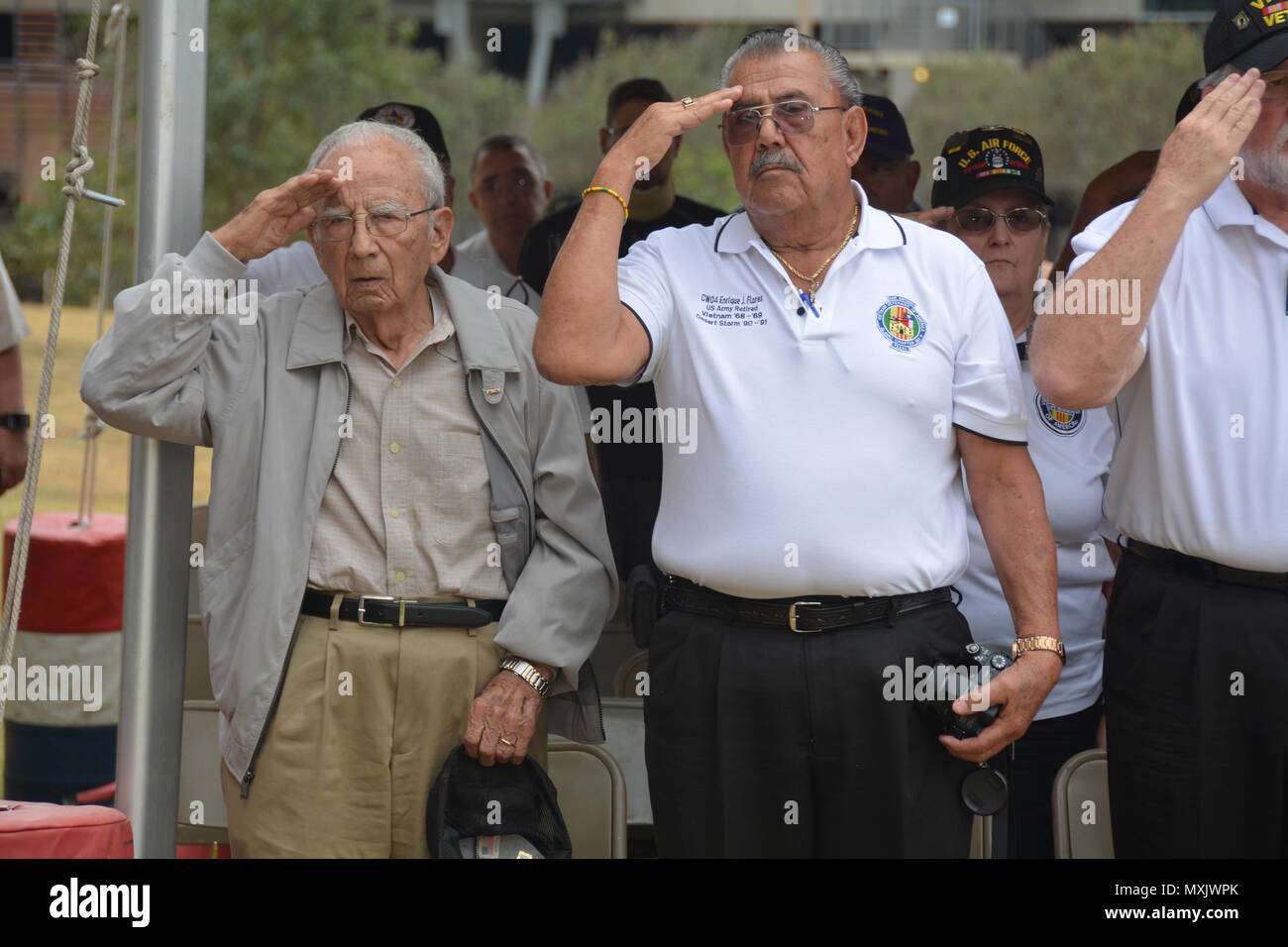 97-year-old World War II Veteran Louis Jimenez and his nephew Vietnam Veteran Enrique Flores salute the flag Nov. 4 during the Brooke Army Medical Center Veterans Day Celebration. (U.S. Army photo by Robert Shields/Released) Stock Photo