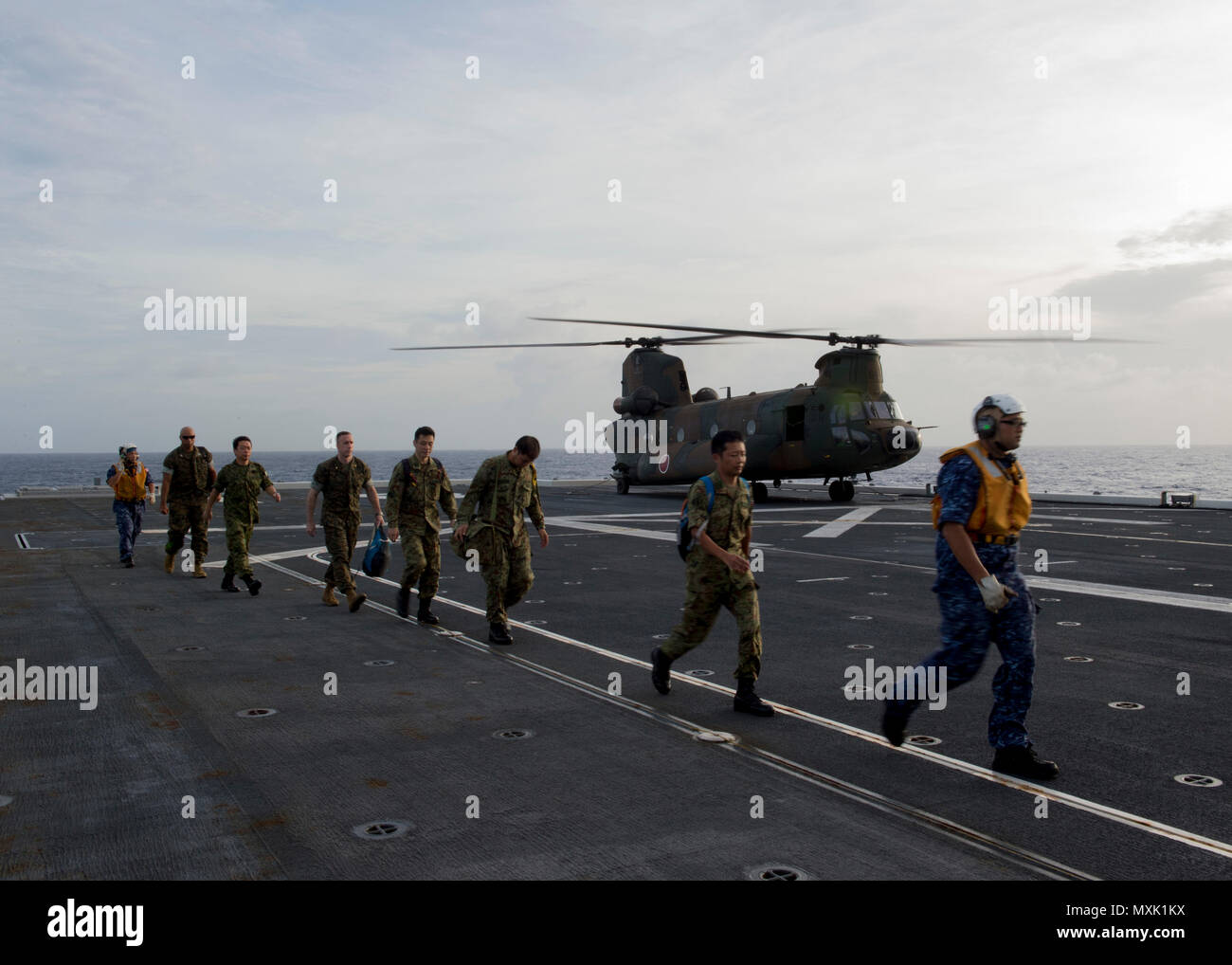 161107-N-ZK021-036  PACIFIC OCEAN (Nov. 7, 2016) U.S. and Japanese military personnel disembark CH-47 JA helicopter during exercise Keen Sword 2017. Keen Sword 17 is a joint and bilateral field training exercise (FTX) between U.S. and Japanese forces meant to increase readiness and interoperability within the framework of the U.S. – Japan alliance. (U.S. Navy photo by Petty Officer 1st Class Nardel Gervacio/Released) Stock Photo