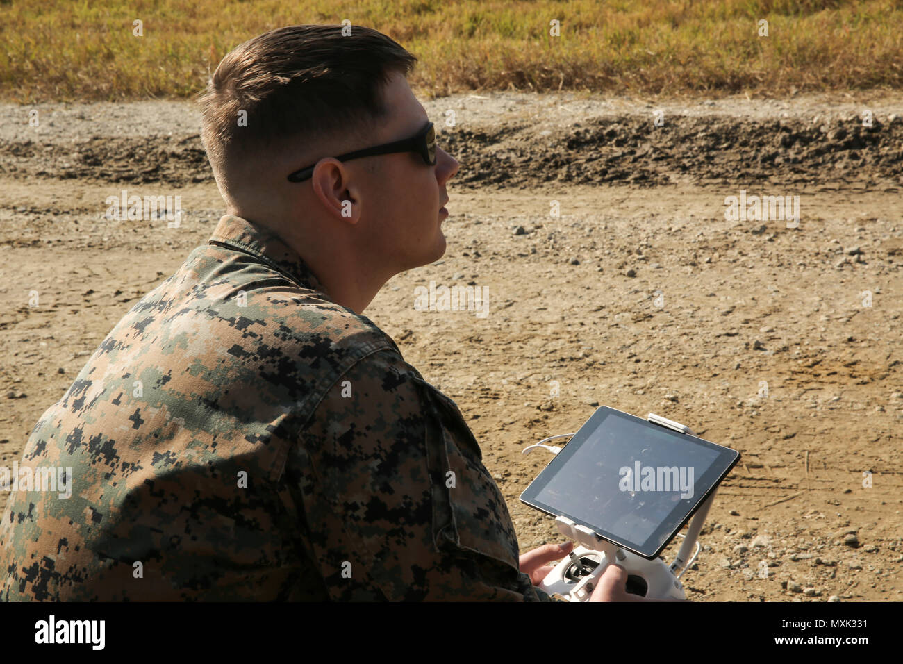 A Marine monitors the visual output from a camera on the DJI Phantom 3 ...