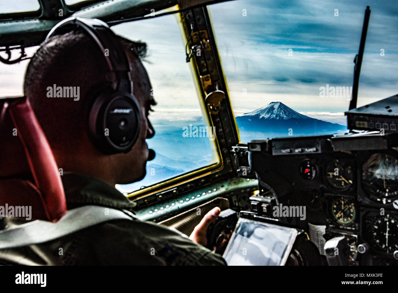36th Airlift Squadron C-130H pilot looks at Mt. Fuji during Keen Sword 2017 on Nov. 10, 2016, near Mt. Fuji, Japan. Originating in 1986, Keen Sword has been a routine military training exercise between the U.S. and Japan. (U.S. Air Force photo by Airman 1st Class Donald Hudson/Released) Stock Photo