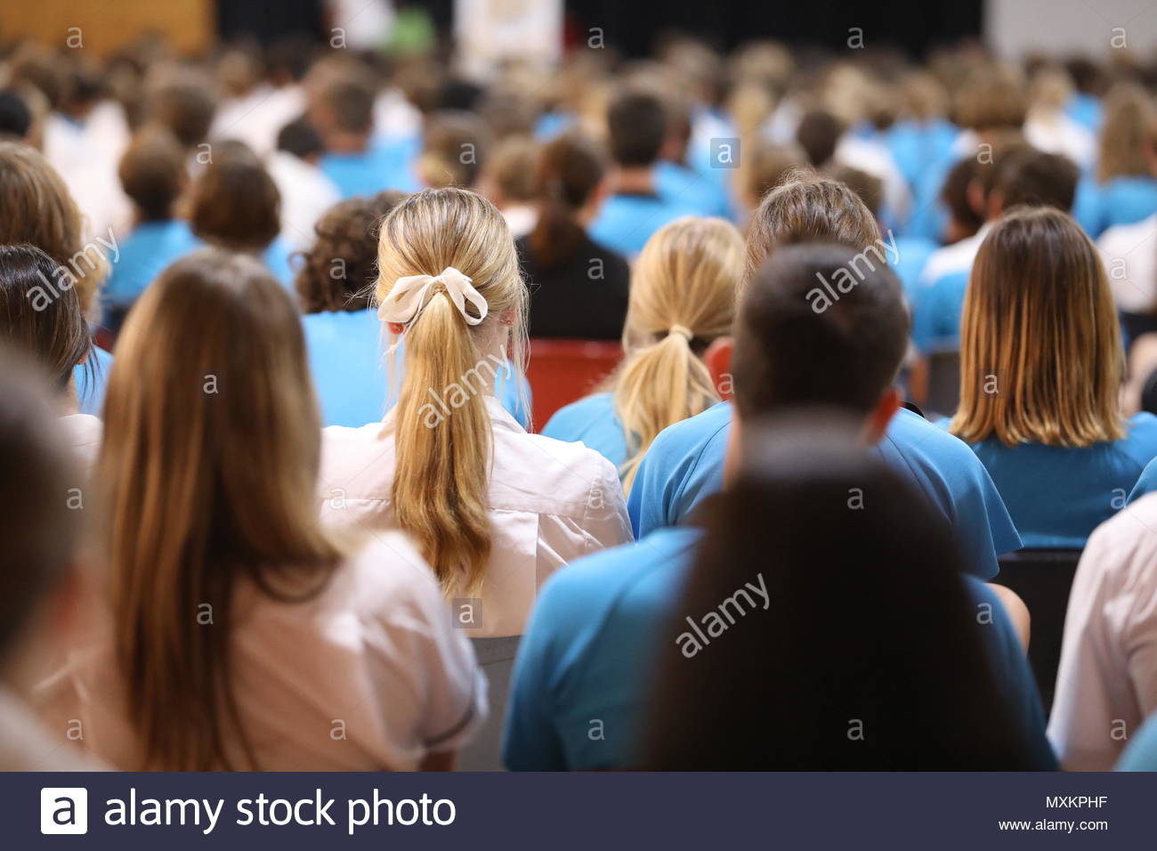 High School Assembly Backs Of Heads Facing The Front Boys And