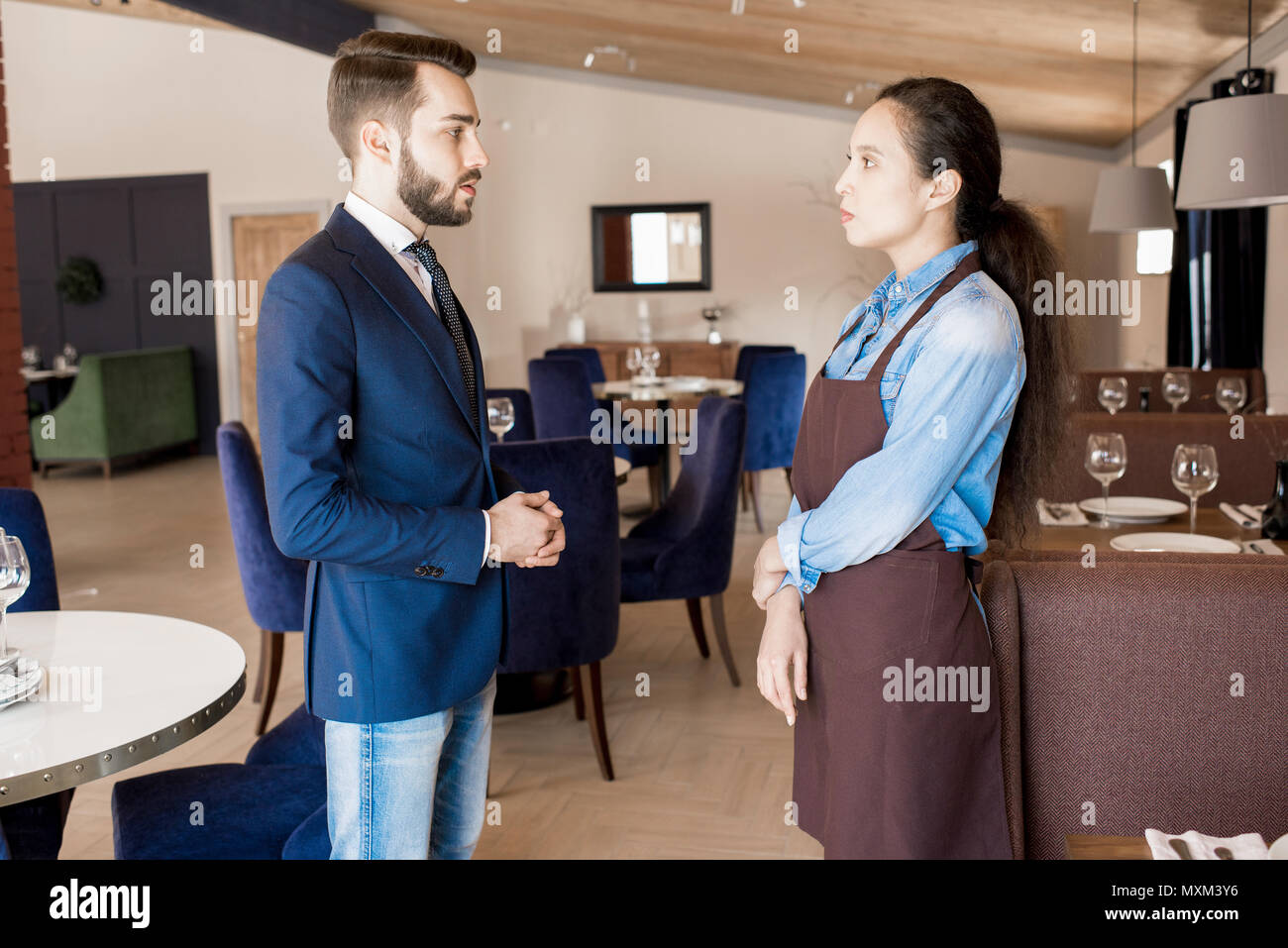 Restaurant manager working with service personnel Stock Photo