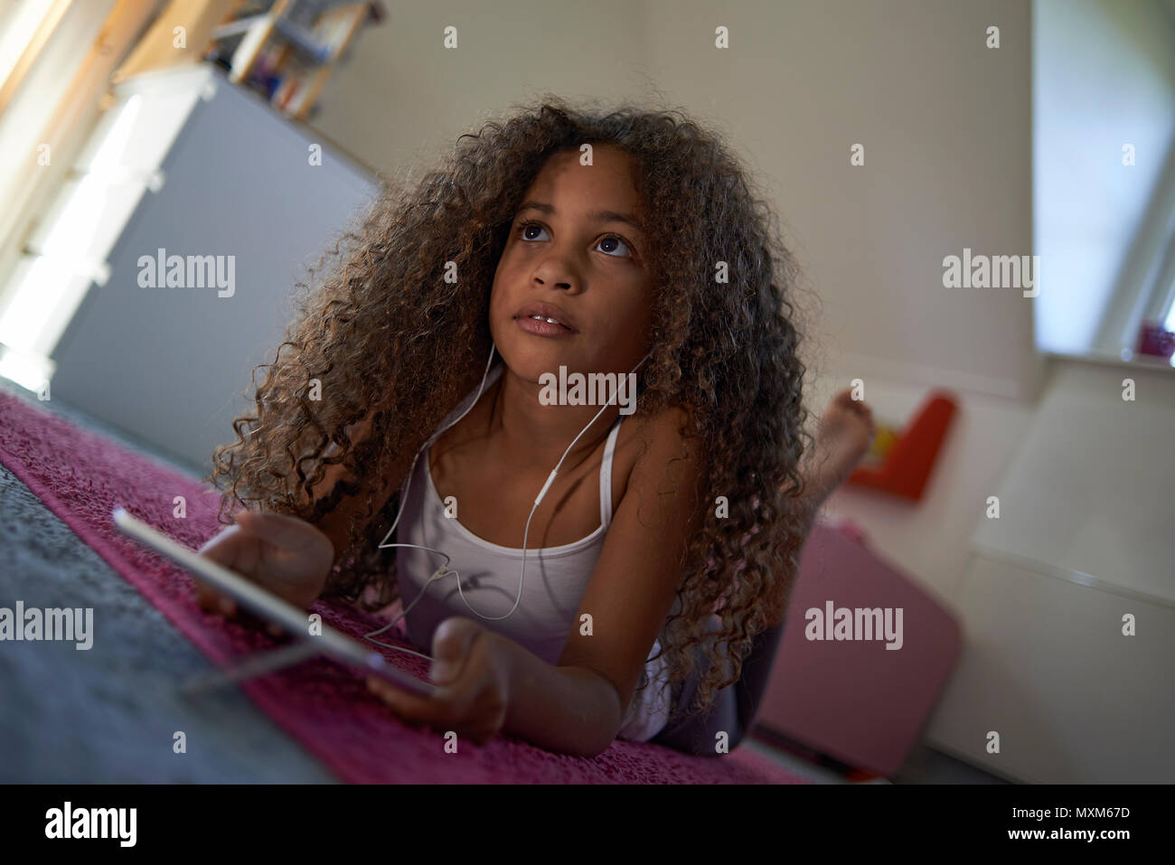 Portrait of a young preteen mixed race girl with big curly hair looking at  camera Stock Photo - Alamy