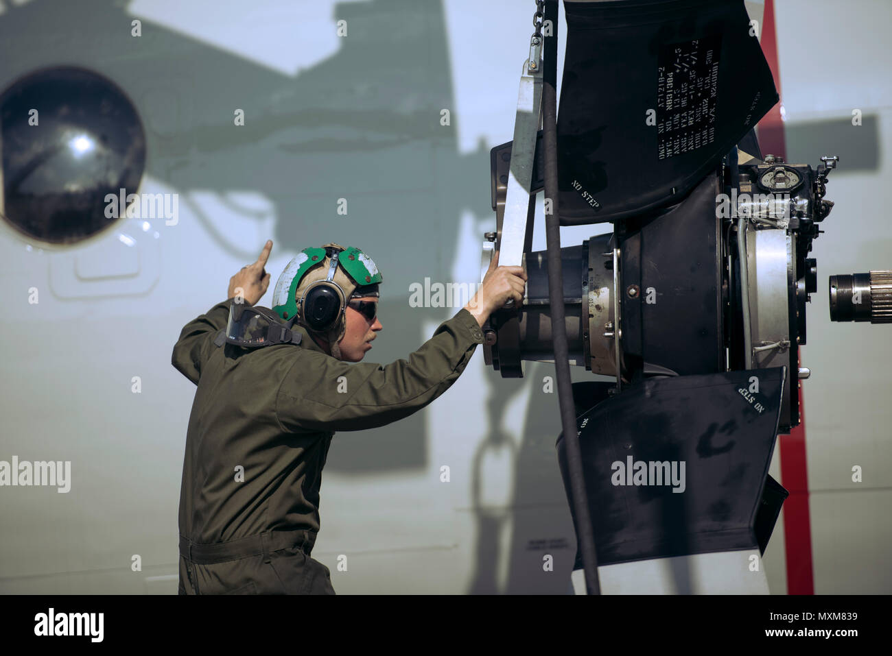 U.S. Navy Petty Officer 3rd Class Brian Mercer, Golden Swordsman Patrol Squadron (VP) 47 aviation mate, works on the P-3 Orion Nov. 8, 2016 while deployed to Kadena Air Base, Japan. The P-3 Orion specializes in intelligence, surveillance, reconnaissance and submarine warfare. (U.S. Air Force photo by Senior Airman Omari Bernard) Stock Photo