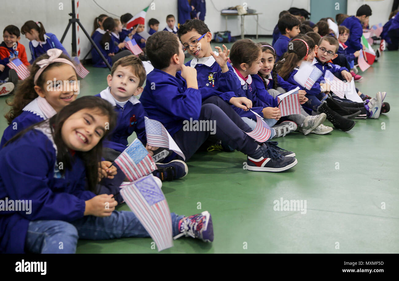 Students from San Giovanni Bosco Elementary School waved hundreds of American flags to greet visiting Marines and sailors from Special Purpose Marine Air-Ground Task Force Crisis Response-Africa in Giarre, Italy, Nov. 15, 2016. The Marines and sailors of SPMAGTF-CR-AF spent time with the children teaching classes on nutrition, exercising and taking many group photos to promoting a positive relationship between the United States and Italy. (U.S. Marine Corps photo by 1st Lt. Eric Abrams/released) Stock Photo