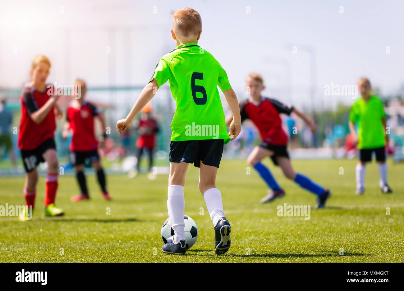 Boys Kicking Soccer Match on Grass. Youth Football Game. Children Sport