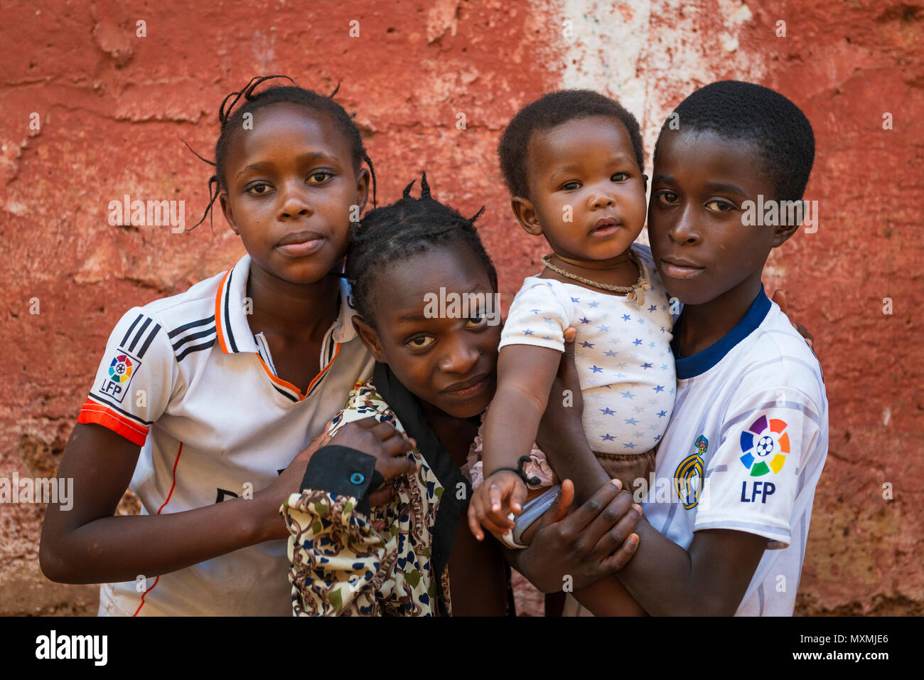 Bissau, Republic of Guinea-Bissau - January 31, 2018: Group of children outside their home at the Cupelon de Cima neighborhood in the city of Bissau,  Stock Photo