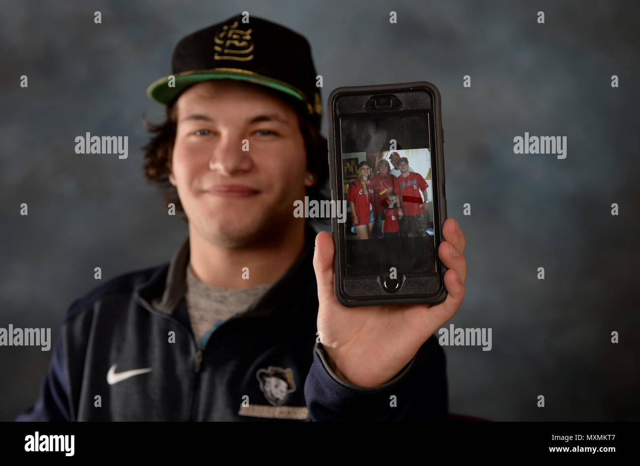 Zach Donnelly, son of the late Dave Donnelly, displays a family photo
