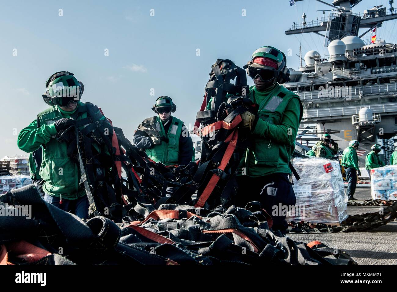 161117NOI810255 PHILIPPINE SEA (Nov. 17, 2016) Sailors organize cargo nets on the flight deck
