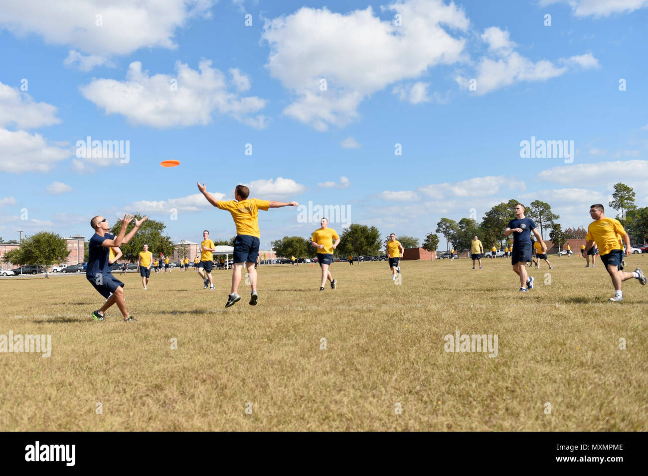 161118-N-FI568-121PENSACOLA, Fla. (Nov. 18, 2016) Sailors at Information Warfare Training Command (IWTC) Corry Station play ultimate Frisbee during the command's 'Warrior Day' event. Warrior Day is a series of athletic competitions aimed at promoting resiliency, teamwork and physical fitness among IWTC Corry Station students. (U.S. Navy photo by Petty Officer 3rd Class Taylor L. Jackson/Released) Stock Photo