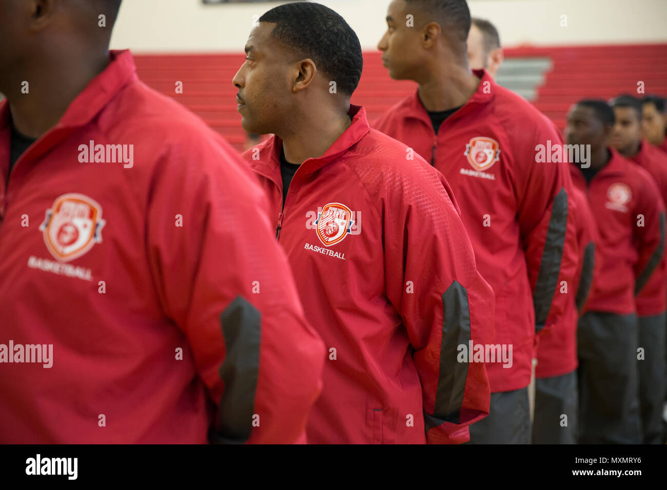 U.S. military members of the All Marine basketball team stand in