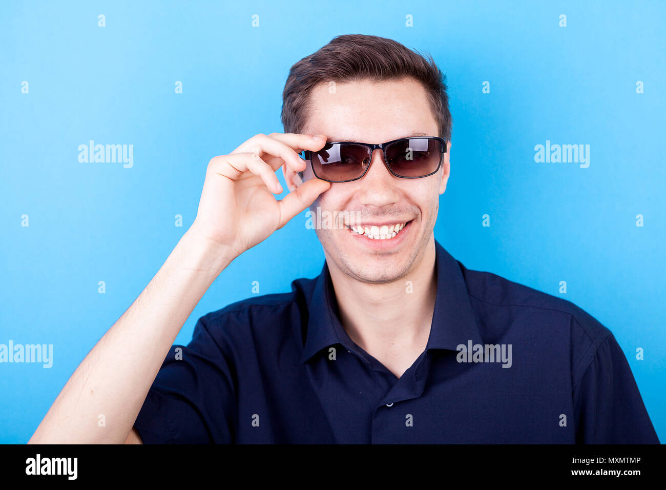 Cool man in casual shirt wearing sunglasses Stock Photo - Alamy