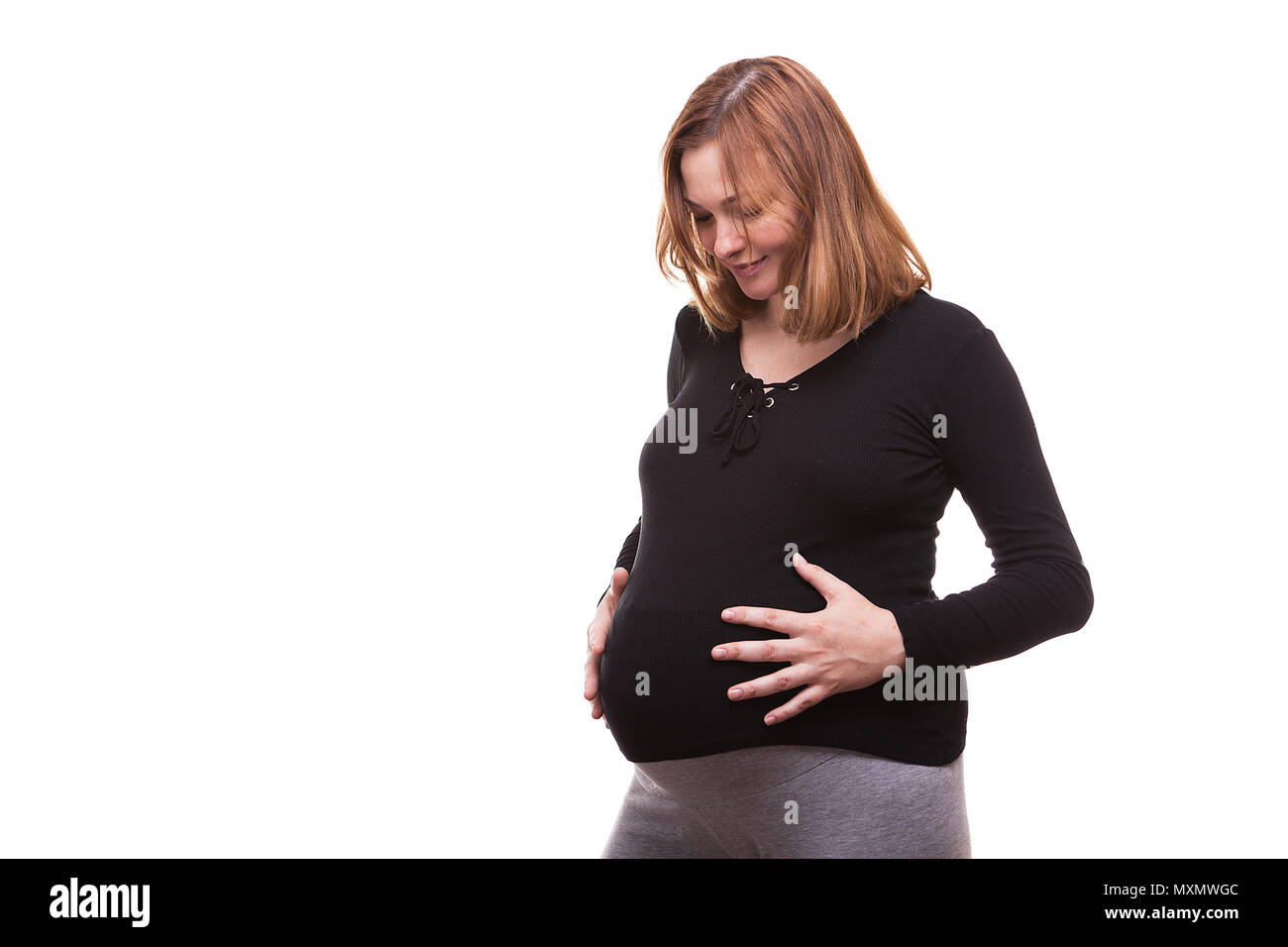 Happy pregnant woman holding her belly Stock Photo - Alamy