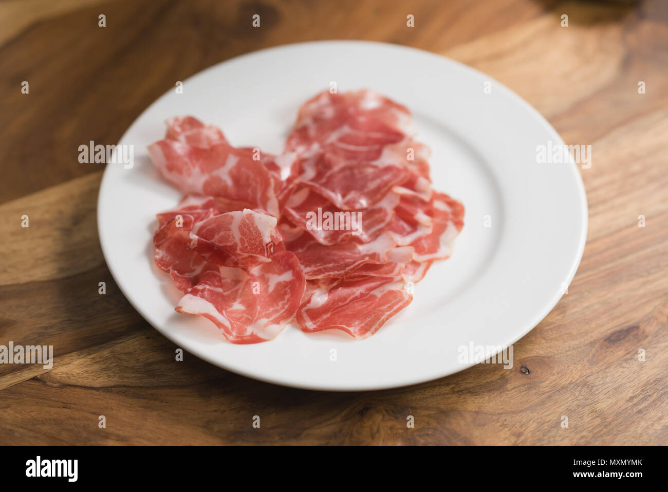 dried coppa ham on white plate Stock Photo: 188545523 - Alamy