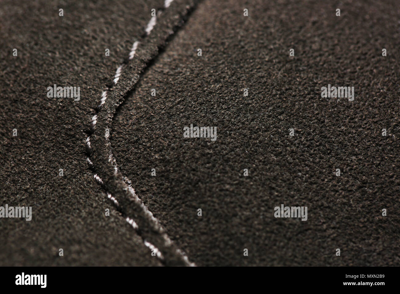 Machine stitch on leather brown fabric close up macro Stock Photo