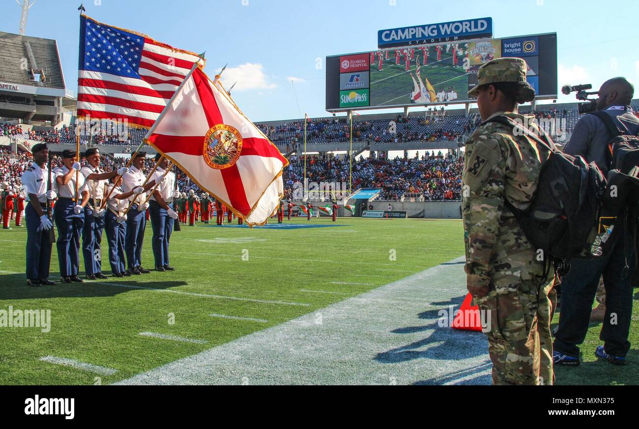Army Master Sgt. Shantell D. Aviles, noncommissioned officer-in-charge, Office of the Inspector General, 143d Sustainment Command (Expeditionary), renders a salute as the national anthem plays inside Camping World Stadium in Orlando, Fla. Aviles, a native of Rockledge, Fla. Was one of several Soldiers from active duty and Reserve units received exclusive access to the field during the Florida Classic, one of the nation’s largest football rivalries between two historically black colleges: Bethune Cookman University and Florida A&M University. The troops engaged with thousands of fans through va Stock Photo