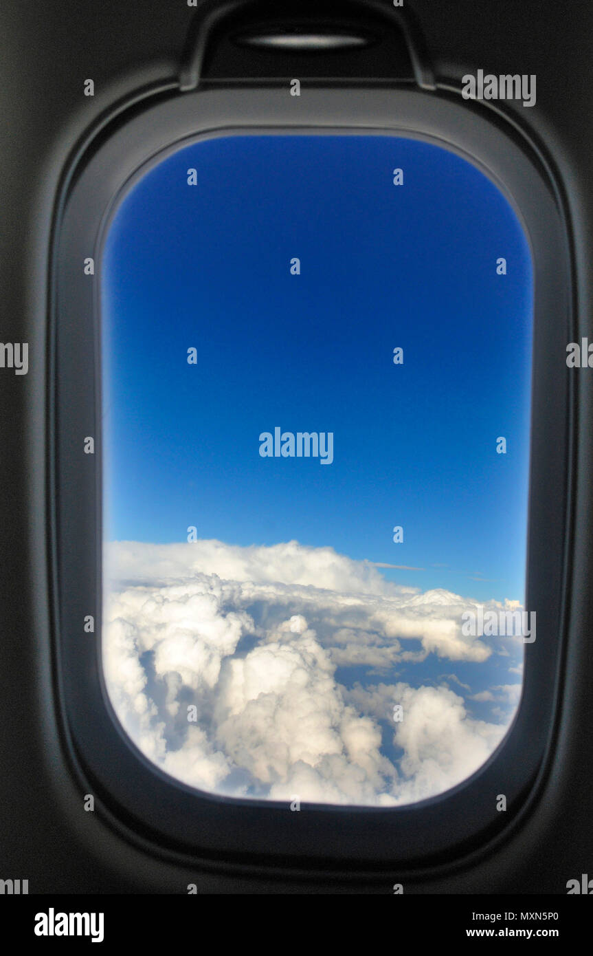 Cloudscape seen through an airplane window Stock Photo