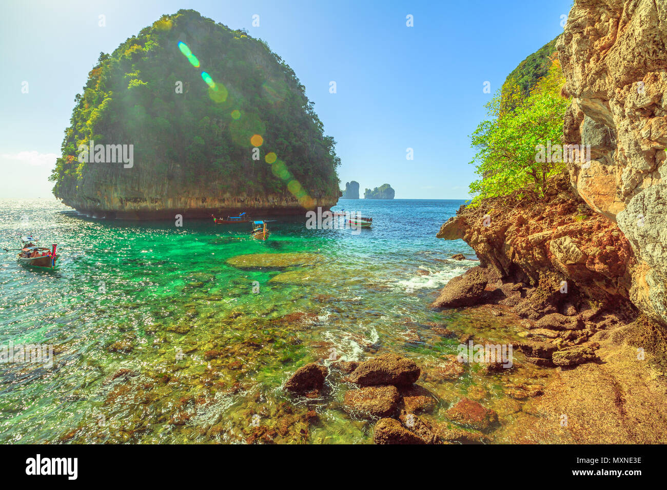 Popular viewpoint of mountain limestone and longtail boats in turquoise waters at Loh Samah bay in Ko Phi Phi Leh, Phi Phi islands, Andaman Sea. Summer season. Beautiful landscape near Maya Bay. Stock Photo