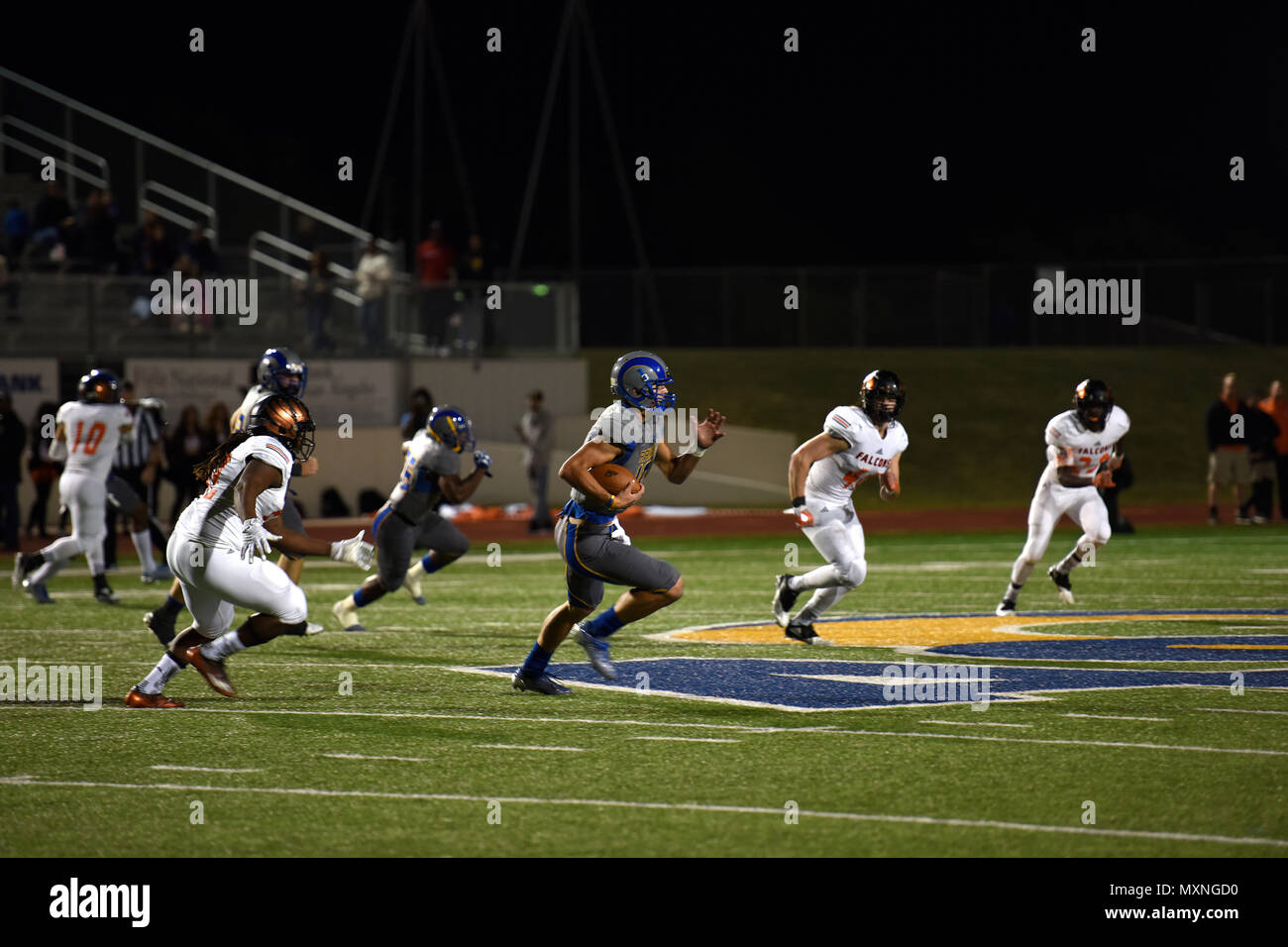 An Angelo State University football player sprints with the ball during the ASU Military Appreciation football game at the San Angelo Stadium, Texas, Nov. 12, 2016. ASU hosted the football game in appreciation of past and present veterans. (U.S. Air Force photo by Airman 1st Class Caelynn Ferguson/ Released) Stock Photo