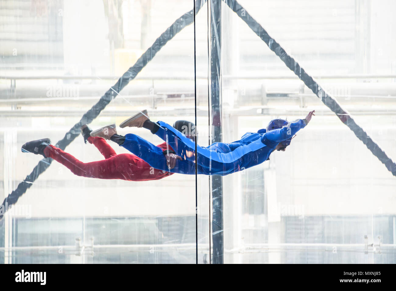 Skydivers in indoor wind tunnel, free fall simulator Stock Photo