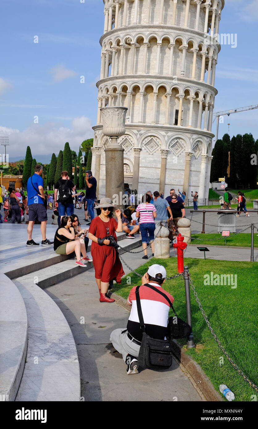 tourists taking photographs at the leaning tower of pisa, italy Stock Photo