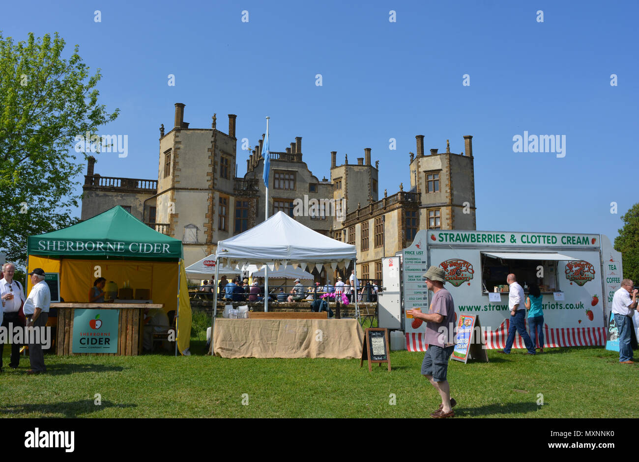Man carrying drinks at Sherborne Castle Country Fair, Sherborne Castle, Dorset, England Stock Photo