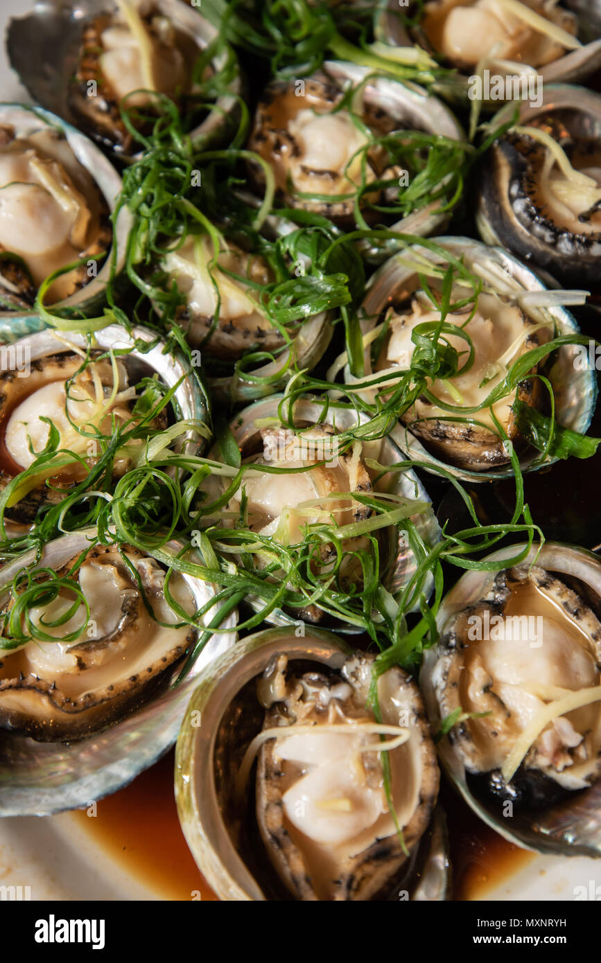 Steamed abalone dish at a chinese restaurant a very popular dish at asian wedding reception ceremonies Stock Photo