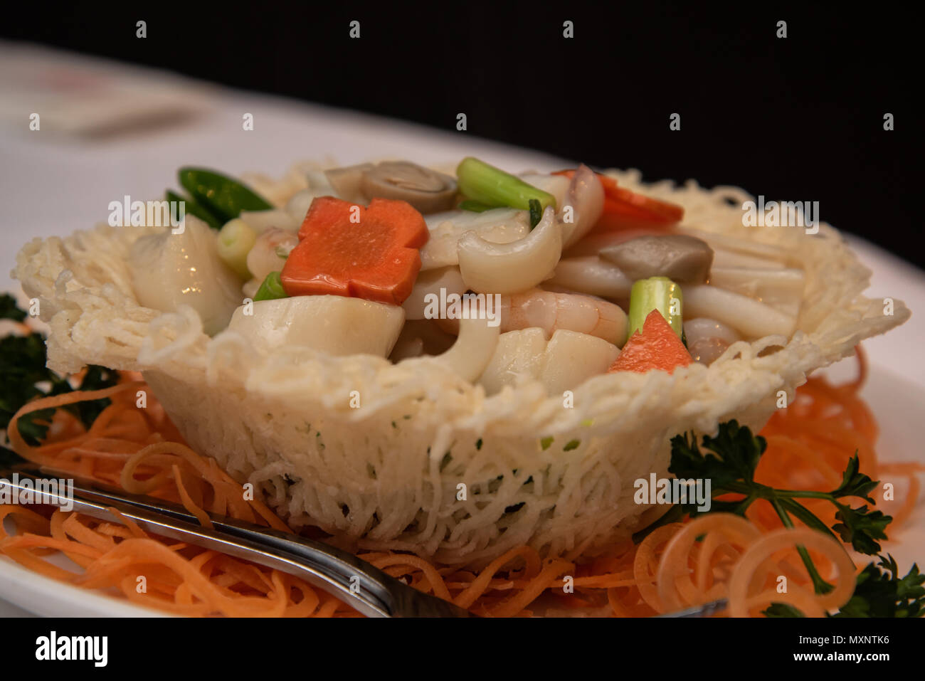 Seafood stir-fry in birds nest a popular dish in a chinese restaurant