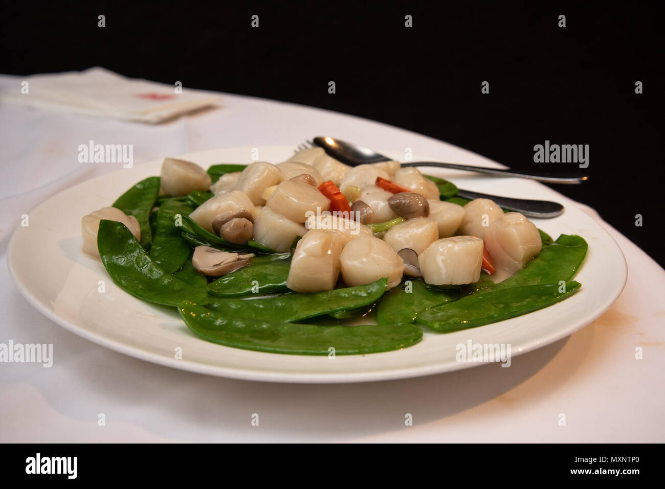 Stirfried scallops with snow pea and mushroom, a popular dish in a