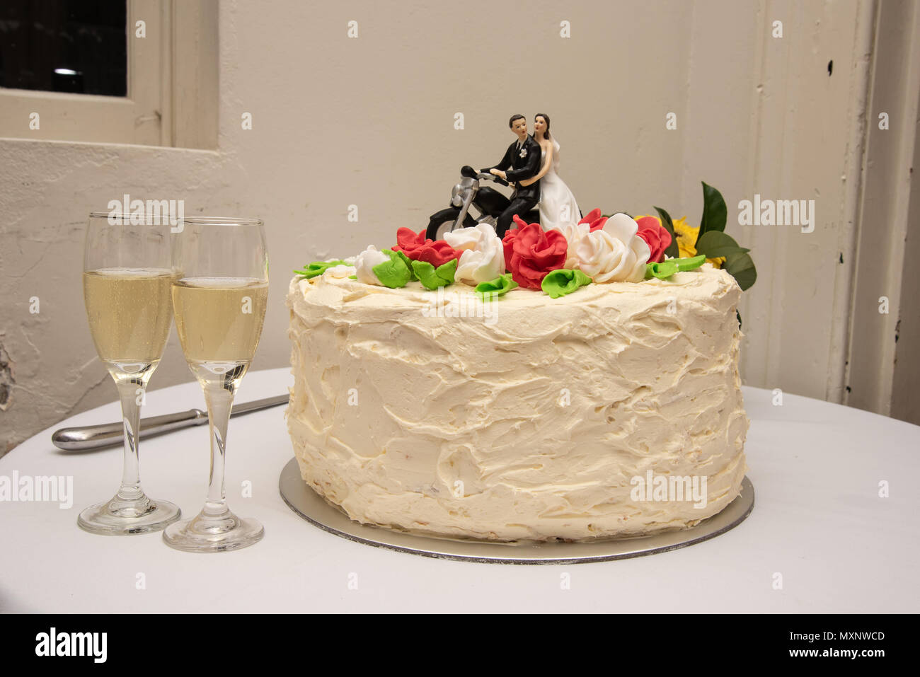 Cake topper: Bride and groom sitting on a motorcycle Stock Photo