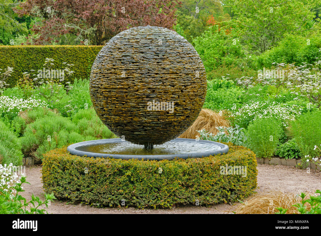CAWDOR CASTLE NAIRN SCOTLAND GARDEN GLOBE FOUNTAIN MADE FROM SLATES AND FLAT STONES IN THE WHITE GARDEN Stock Photo