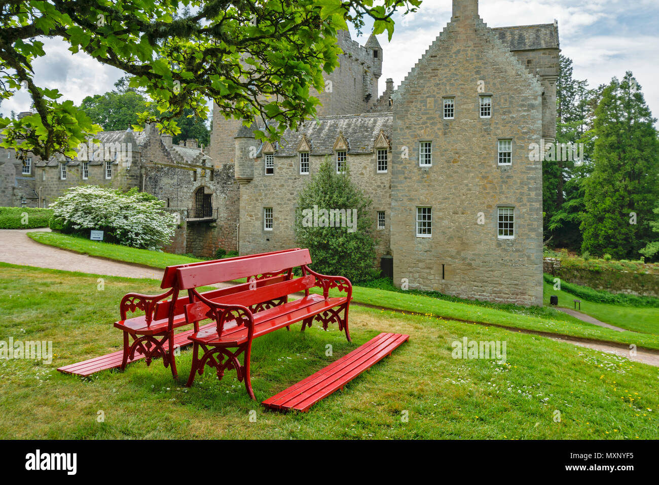 CAWDOR CASTLE NAIRN SCOTLAND RED BENCH UNDER A TREE IN FRONT OF THE
