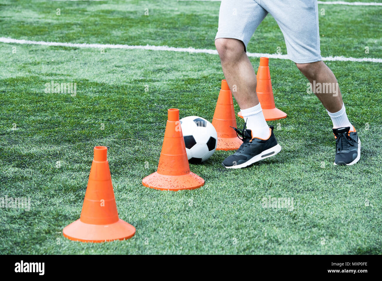 Man Leading Ball between Cones Stock Photo Alamy
