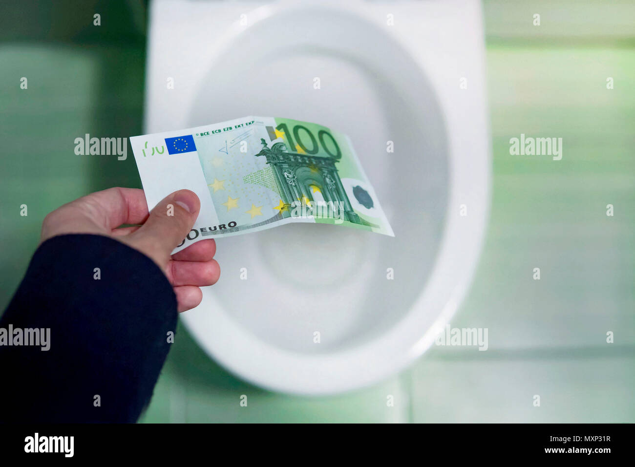 concept of senseless waste of money, loss, useless waste, large water costs, waste of money concept with euro bill and toilet. loss of money, losing m Stock Photo