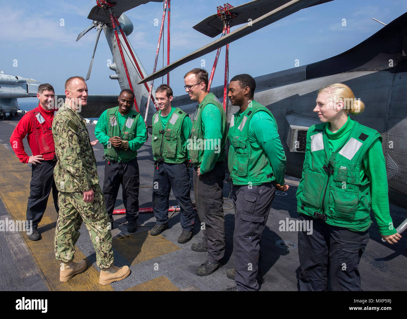 161124-N-TO519-077 U.S. 5TH FLEET AREA OF OPERATIONS (Nov. 24, 2016) Master Chief Petty Officer of the Navy Steven Giordano speaks to Sailors, from the Helicopter Sea Combat Squadron (HSC) 22, aboard the amphibious assault ship USS Wasp (LHD 1). Wasp is deployed with the Wasp Amphibious Ready Group to support maritime security operations and theater security cooperation efforts in the U.S. 5th Fleet area of operations. (U.S. Navy photo by Petty Officer 2nd Class Nathan Wilkes/Released) Stock Photo