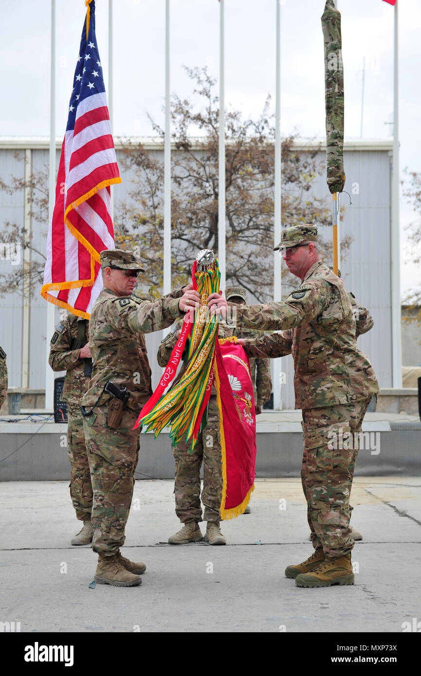 BAGRAM AIRFIELD, AFGHANISTAN (Nov. 29, 2016) - U.S. Army Lt. Col. Michael Tyler and Command Sgt. Maj. Thomas Conner unfurl the colors of the 184th Ordnance Battalion (Explosive Ordnance Disposal) signifying their assumption of the Task Force EOD mission here in Afghanistan.  The 184th EOD Bn recently deployed from Fort Campbell, Ky.  Photo by Bob Harrison, U.S. Forces Afghanistan Public Affairs. Stock Photo