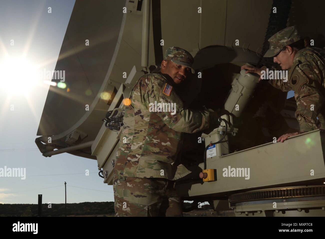 Staff Sgt. Anthony Denton, a multiband hub section chief, and Pfc. Melanie Tobias, a satellite