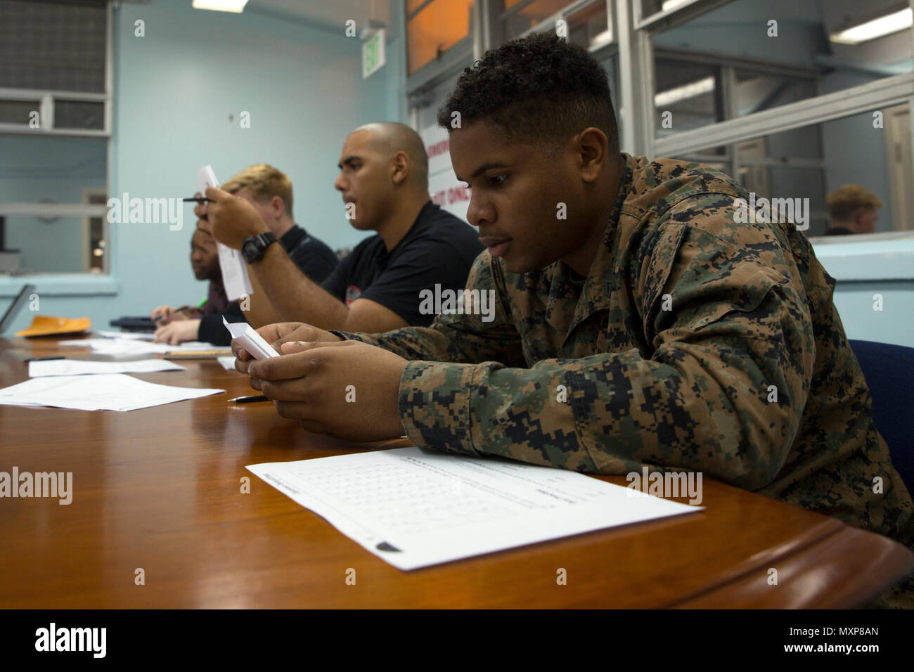 Students study Japanese characters during a Survival Japanese Language Class Nov. 29, 2016 on Marine Corps Air Station Futenma, Okinawa, Japan. The class provided students with the opportunity to learn to speak, read and write basic Japanese words, phrases and characters. The lesson covered the three basic Japanese forms of writing called hiragana, katakana and kanji. (U.S. Marine Corps photo by Cpl. Janessa K. Pon) Stock Photo