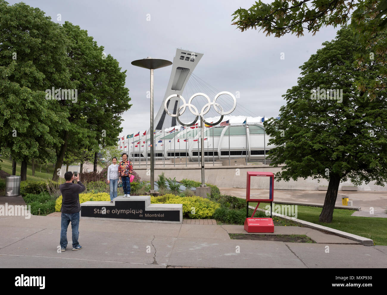 Tourists pose for a photograph at The Olympic Park, Montreal Canada. Stock Photo