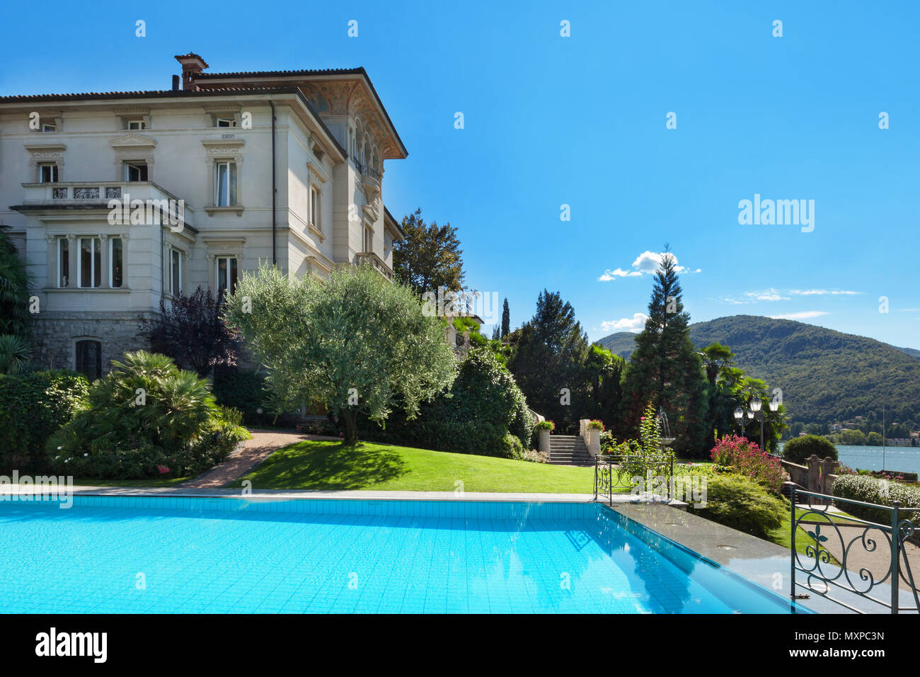 external of a villa, beautiful swimming pool overlooking the lake Stock Photo