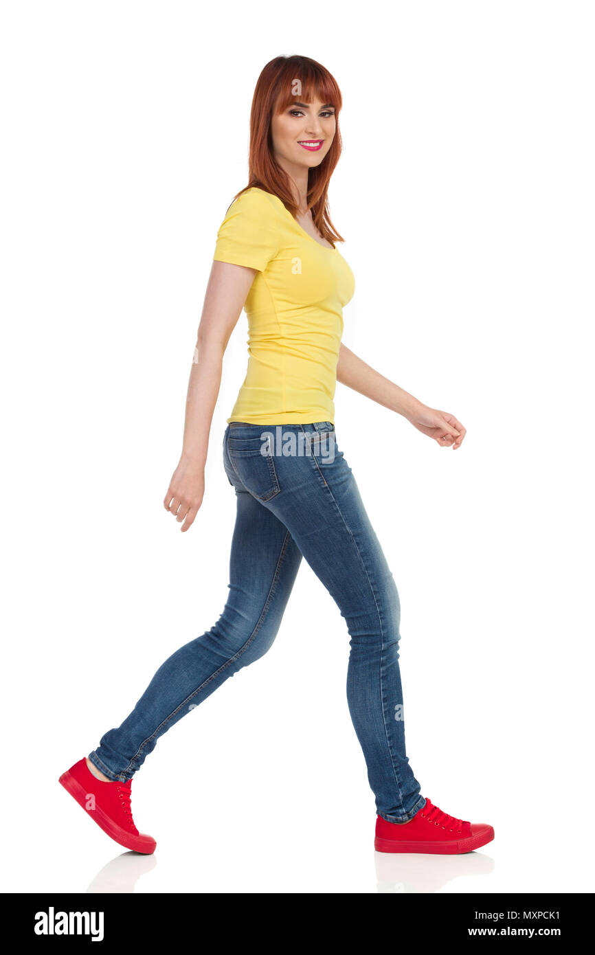 Young woman in yellow shirt, jeans and 