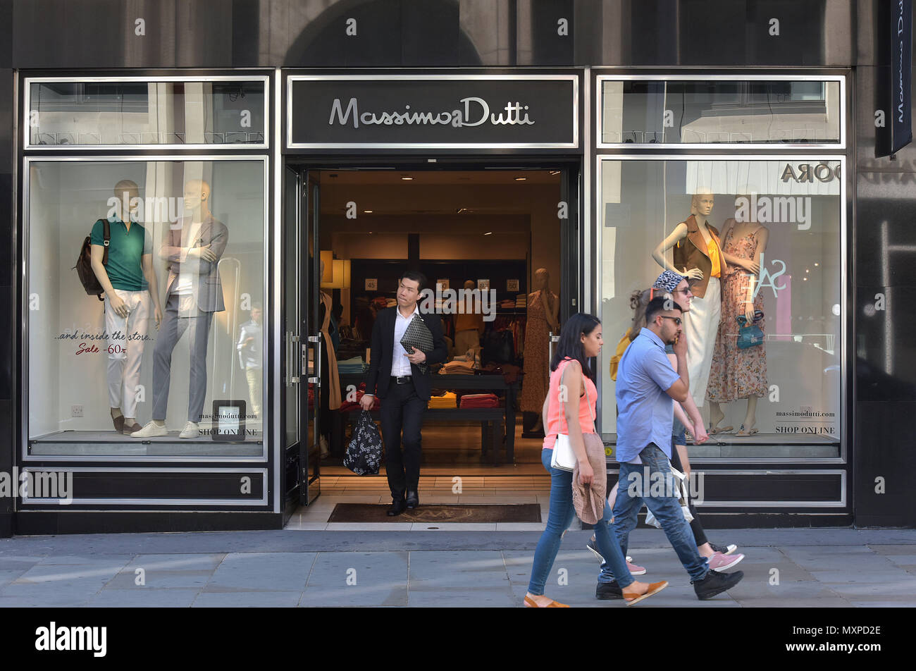Tourists and shoppers walk past a branch of Massimo Dutti, the women’s clothing retailer, owned by Inditex, in Covent Garden, London. Stock Photo