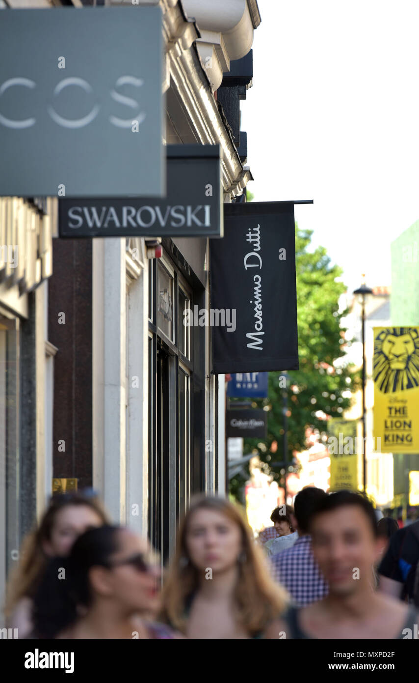 Tourists and shoppers walk past a branch of Massimo Dutti, the women’s clothing retailer, owned by Inditex, in Covent Garden, London. Stock Photo