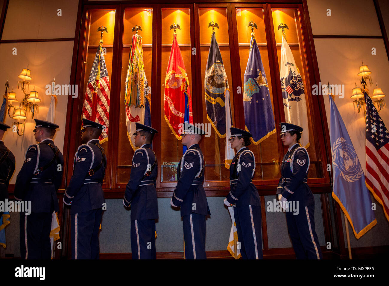 Members of the Yokota Air Base Honor Guard prepare to present the colors during the United Nations Day 71st Anniversary Celebration in Tokyo, Japan, Nov. 21, 2016. United Nations Day commemorates the anniversary of the United Nations Charter in 1945 and has been celebrated as UN Day since 1948. (U.S. Air Force photo by Airman 1st Class Donald Hudson/Released) Stock Photo