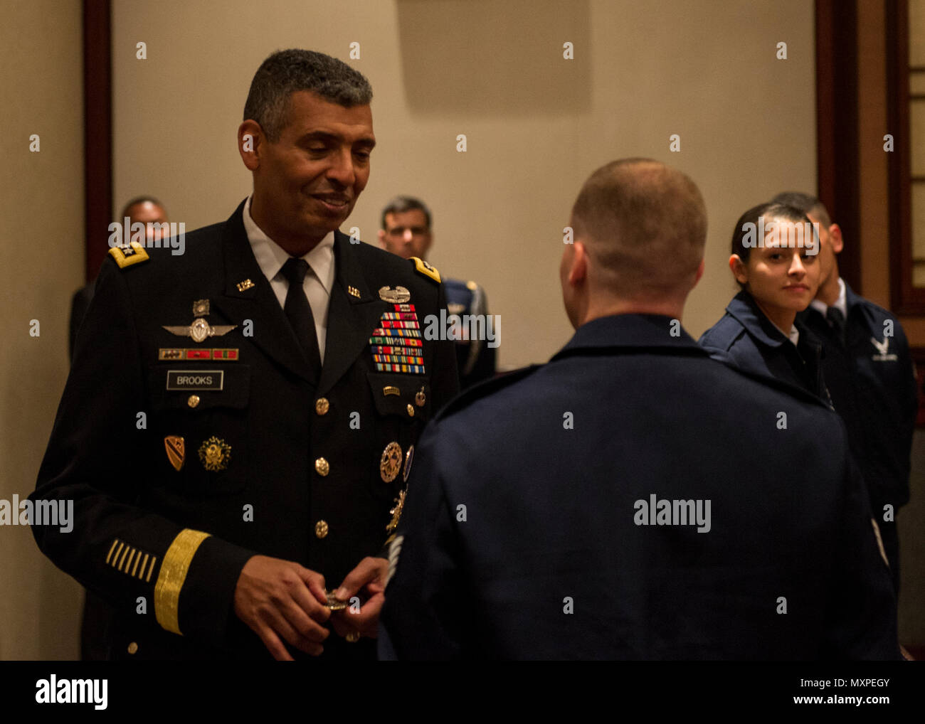 U.S. Army Gen. Vincent K. Brooks, United Nations Command commander, presents command coins to the members of the Yokota Air Base Honor Guard for their performance during the United Nations Day 71st Anniversary Celebration in Tokyo, Japan, Nov. 21, 2016. United Nations Day commemorates the anniversary of the United Nations Charter in 1945 and has been celebrated as U.N. Day since 1948. (U.S. Air Force photo by Airman 1st Class Donald Hudson/Released) Stock Photo