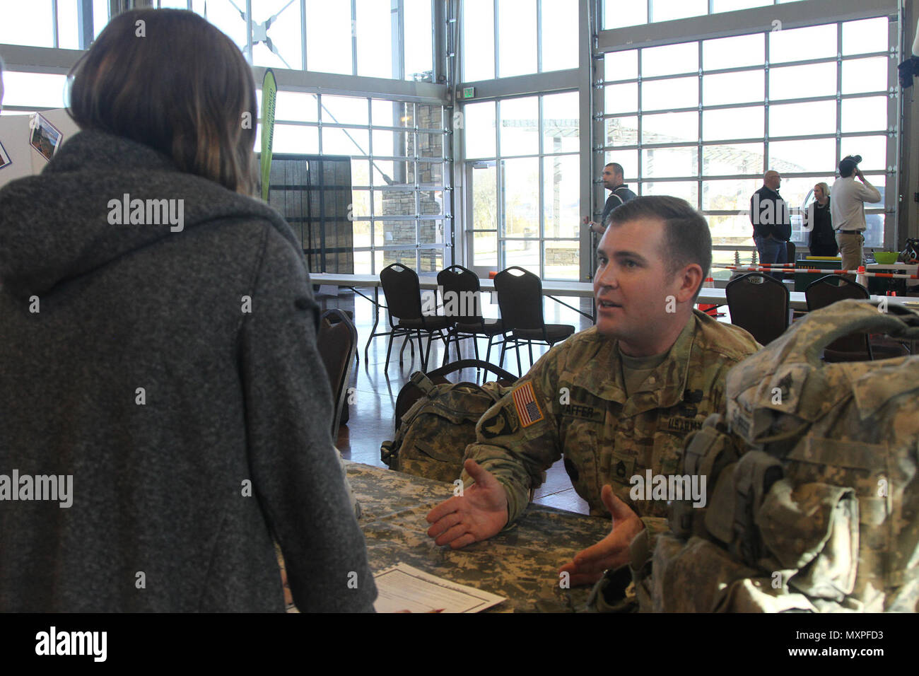 Sgt. 1st Class Shannon Shaffer, a combat engineer with 101st Airborne Division (Air Assault) Sustainment Brigade, 101st Abn. Div., speaks to a student, Nov. 16, 2016, during the Eighth-Grade Career Exploration Day hosted by the Clarksville-Montgomery County School System at the Wilma Rudolph Event Center in Clarksville, Tn. (U.S. Army photo by Sgt. Neysa Canfield/101st Airborne Division Sustainment Brigade Public Affairs) Stock Photo