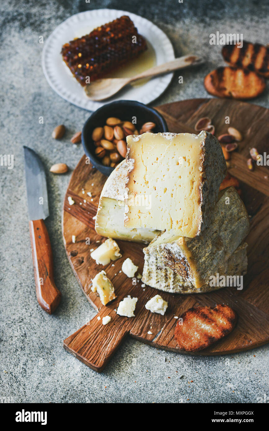Cheese platter with cheese assortment, nuts, honey and bread Stock