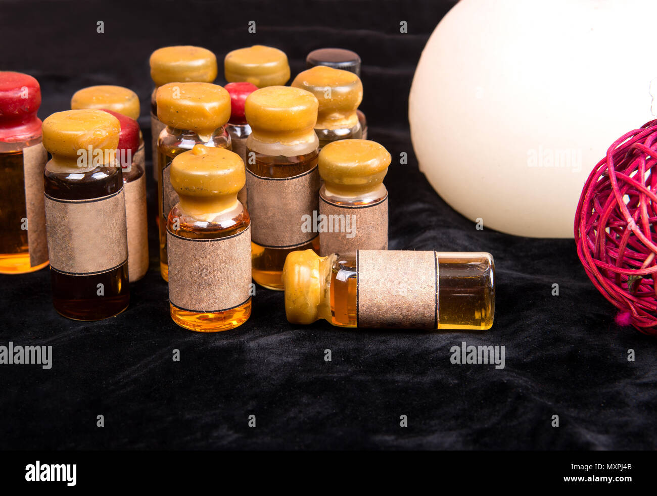 Magic potion in a small bottle closeup on black background Stock Photo