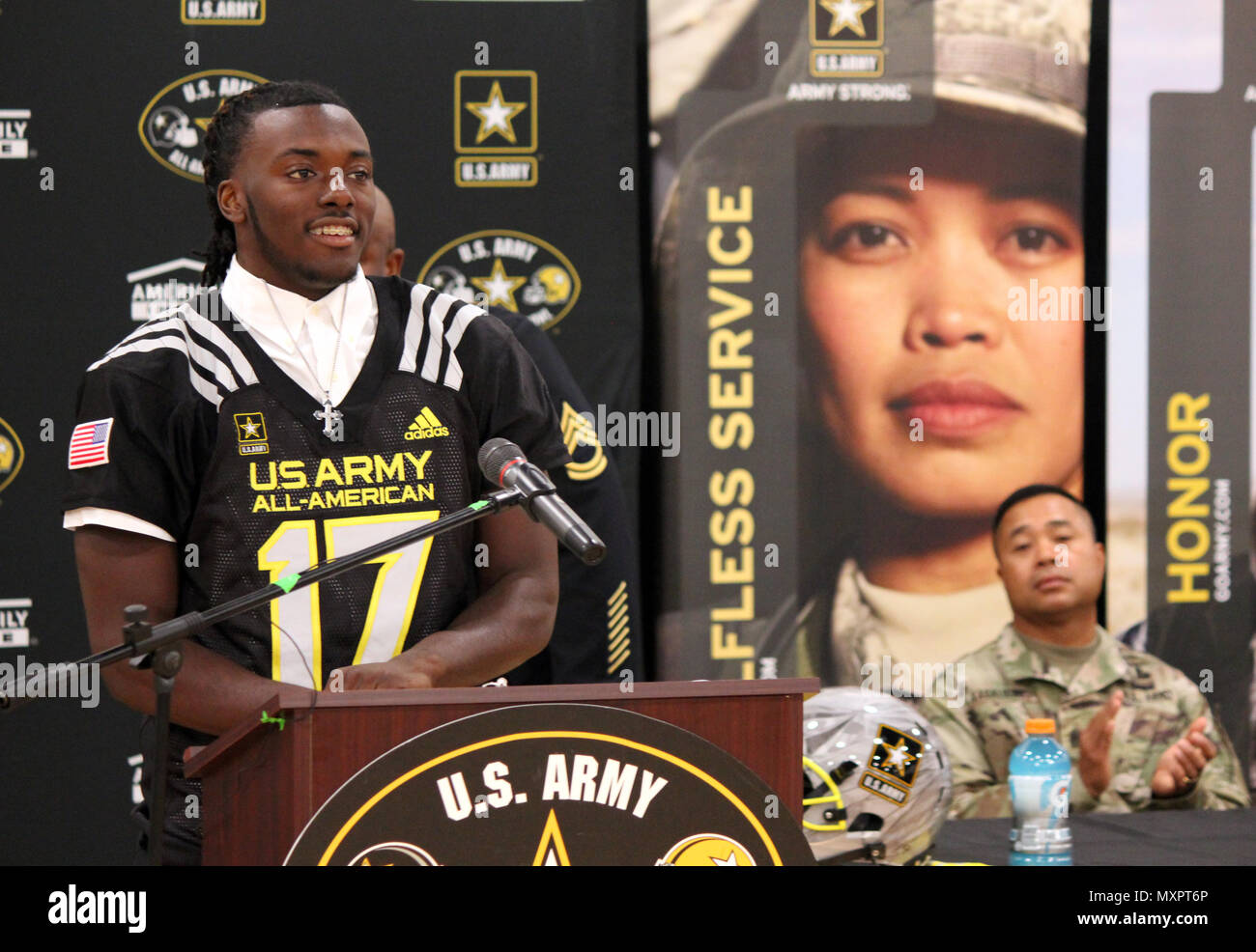 Command Sgt. Major Walter Tagalicud, the Senior Enlisted Advisor for the  3rd Infantry Division, looks on as the U.S. Army selects Richard LeCounte  of Liberty County High School to play in the