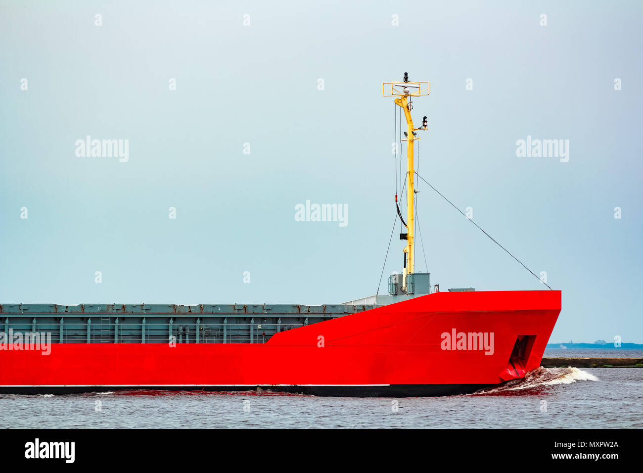 Orange cargo ship. Logistics and merchandise transportations Stock